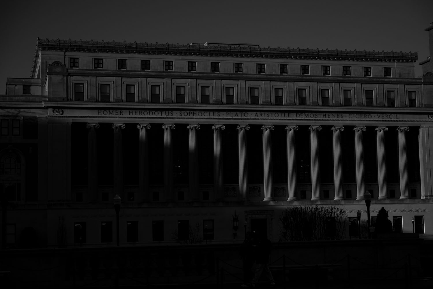 black and white photograph of Columbia University building in shadows