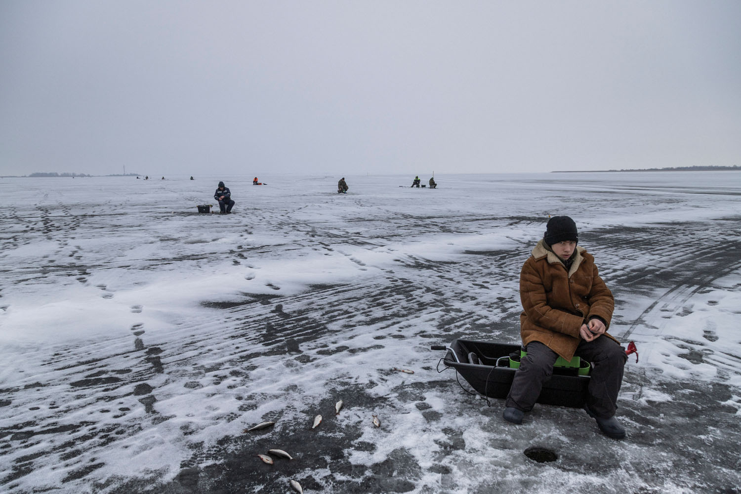 Ice fishing on Lake Peipus, feet away from the Russian border. Beresje, Estonia, February 2025.