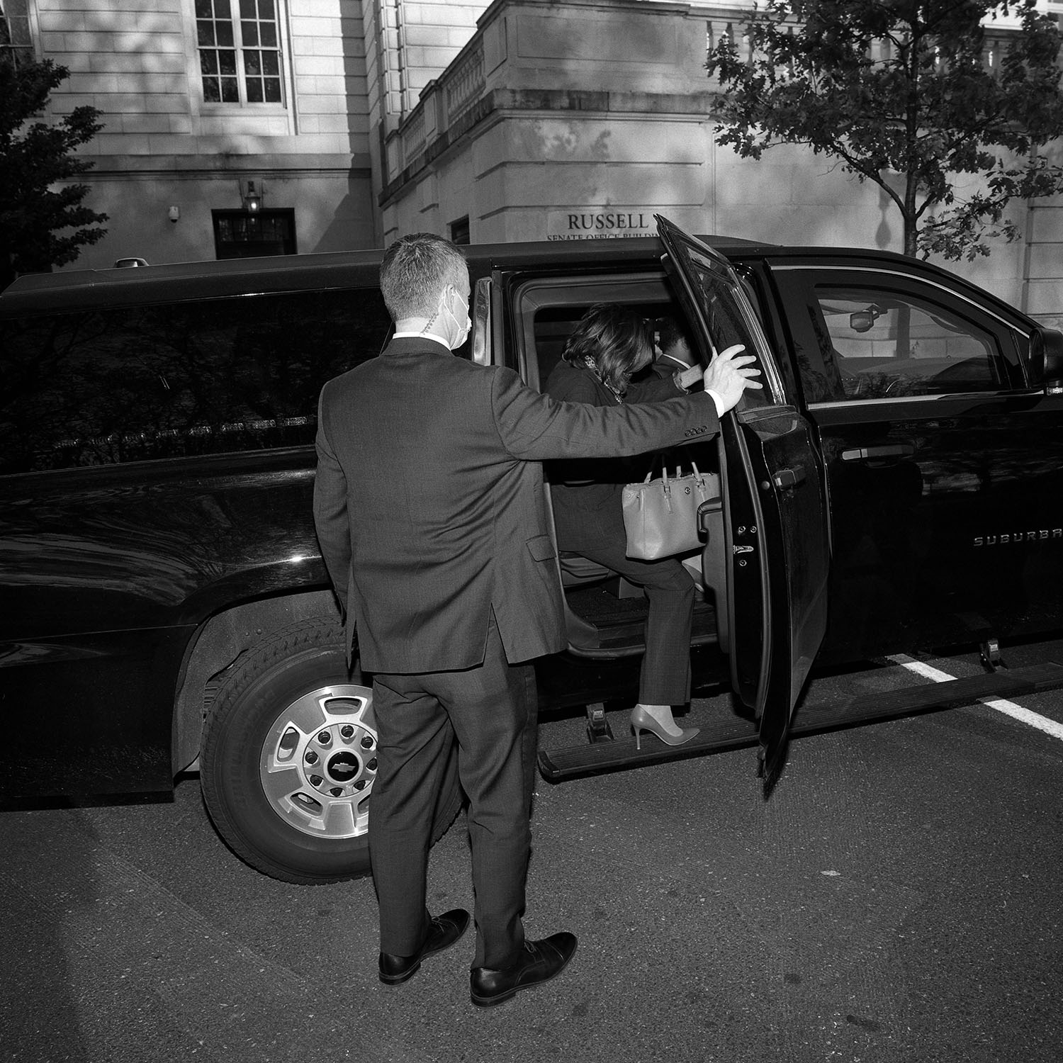 Security guard holding SUV door