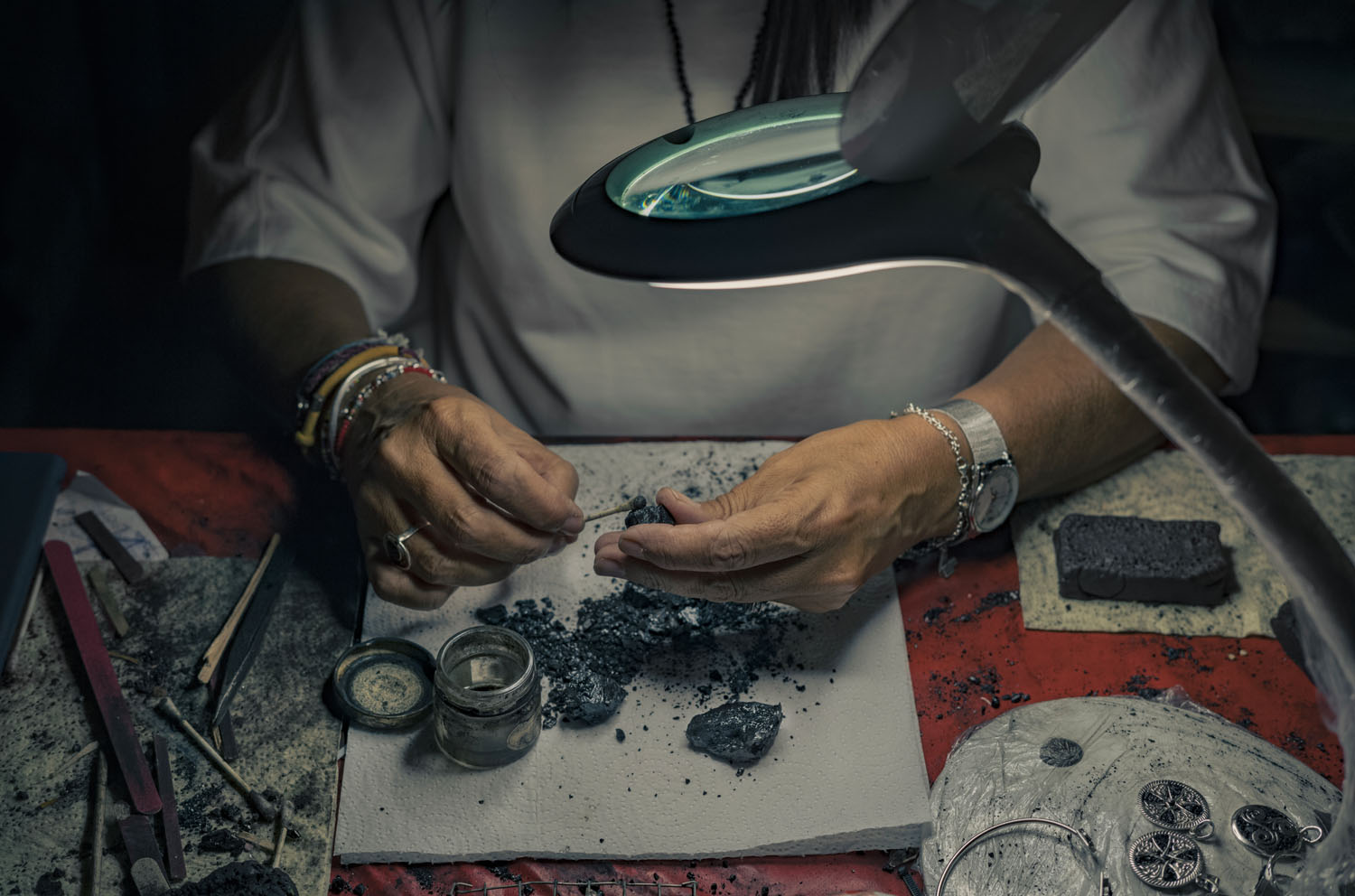 a women's hands making jewelry