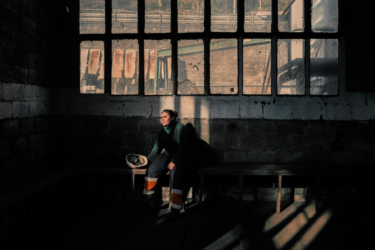 Women sits in an industrial space 