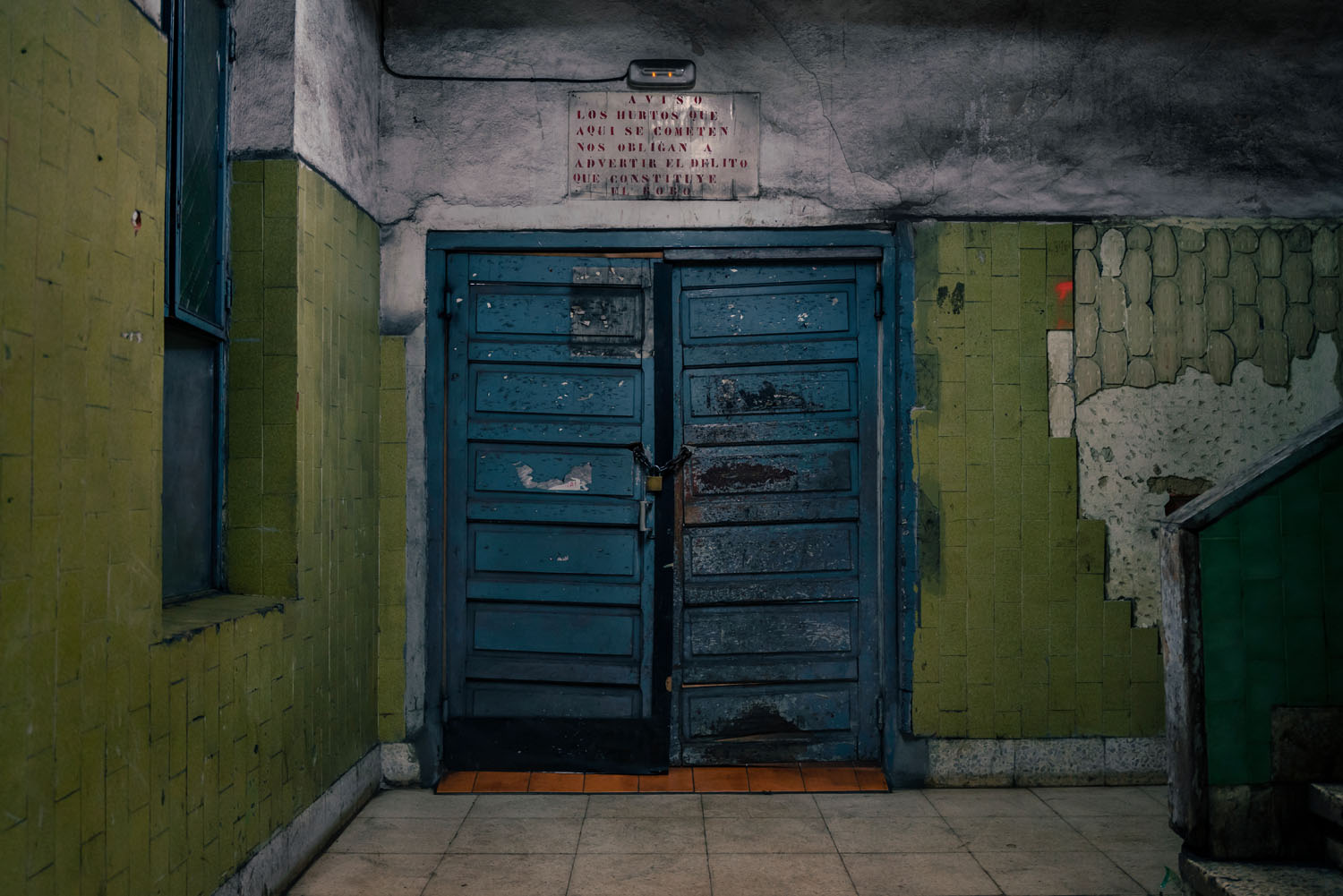 double steel doors painted blue with green walls