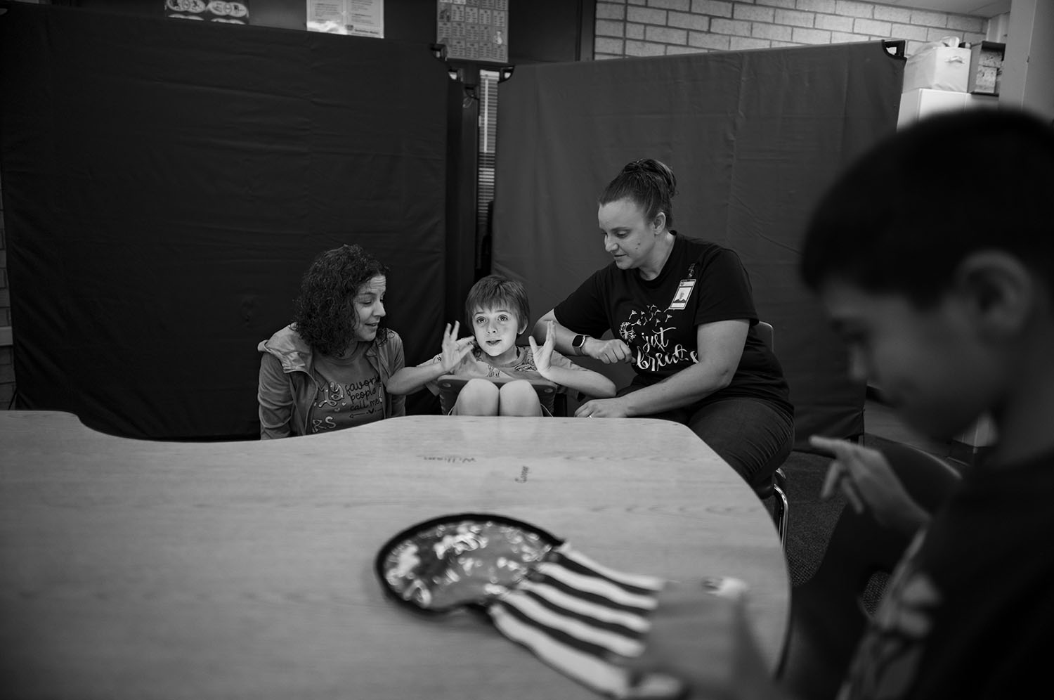 Boy surrounded by adults.