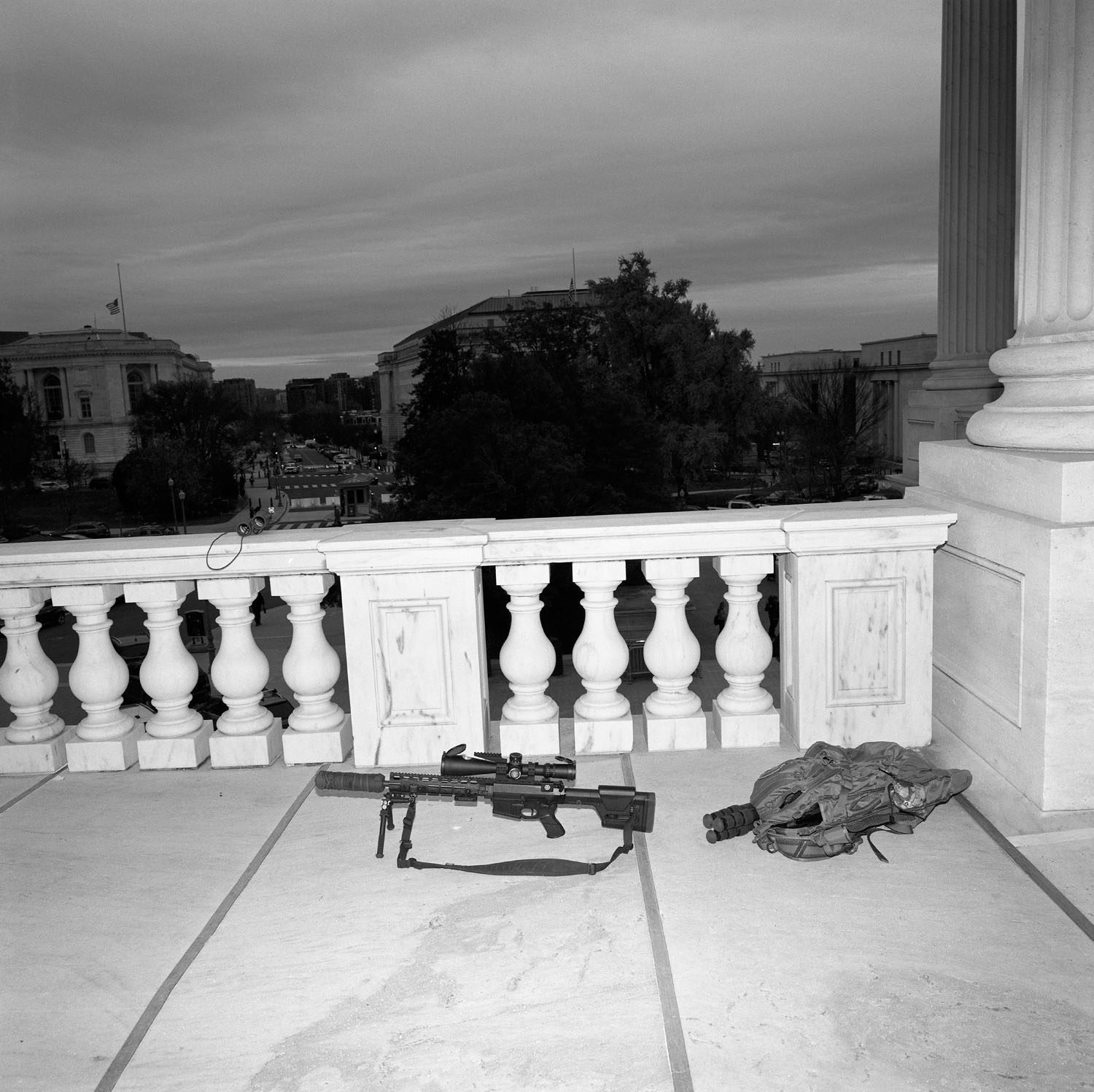 Gun rests on balcony.