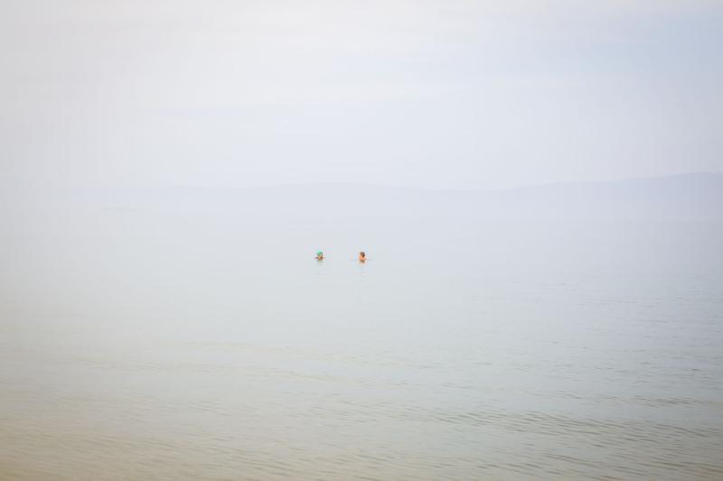 Two people swimming in the lake