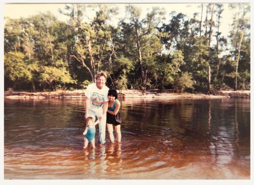 People stand in pond.
