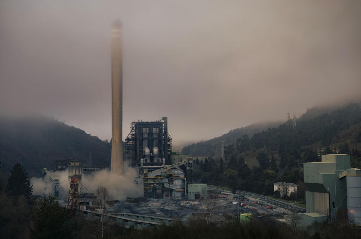 explosion at an industrial facilty, mountains in the background