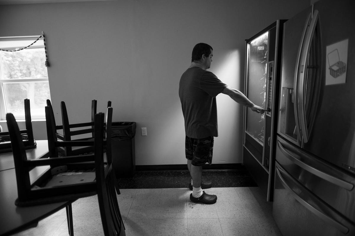 Boy uses vending machine.