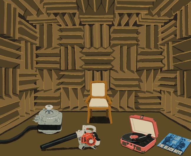 Sound proofed room with a leaf blower, chair, record player on the floor.